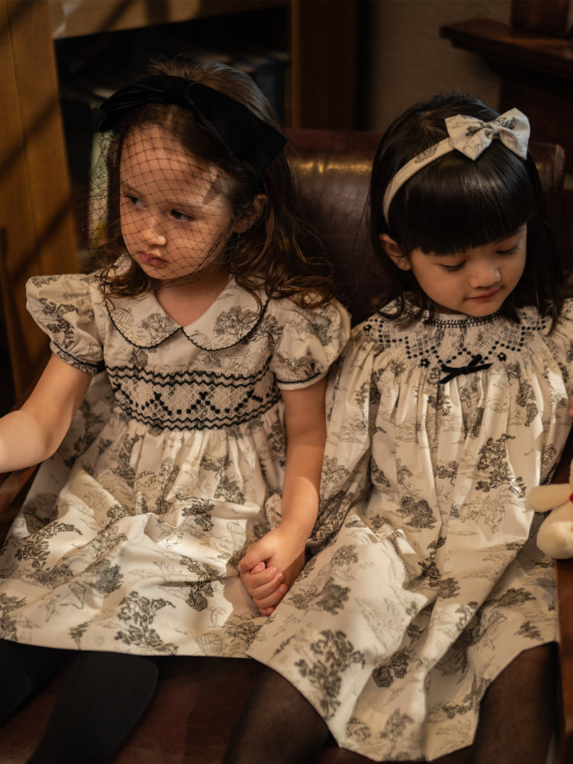girls wearing classic gothic black and white victorian dresses with floral prints